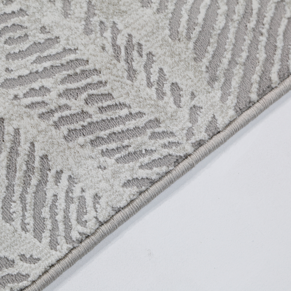 Light gray woven rug with textured wavy line design for modern interiors