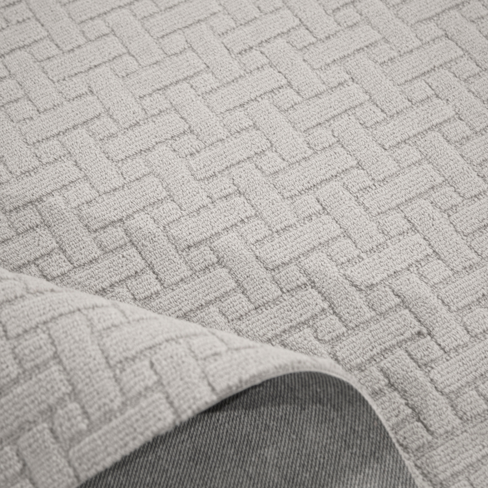 Textured light gray woven rug with modern basketweave pattern