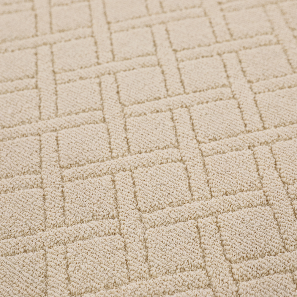 Light beige woven rug with textured geometric design for stylish home decor.