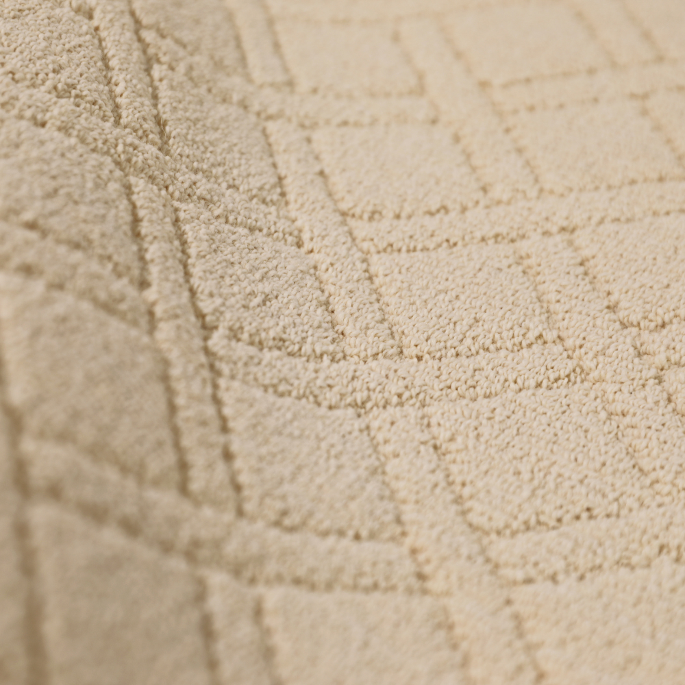 Textured light beige geometric woven rug for stylish home interiors.