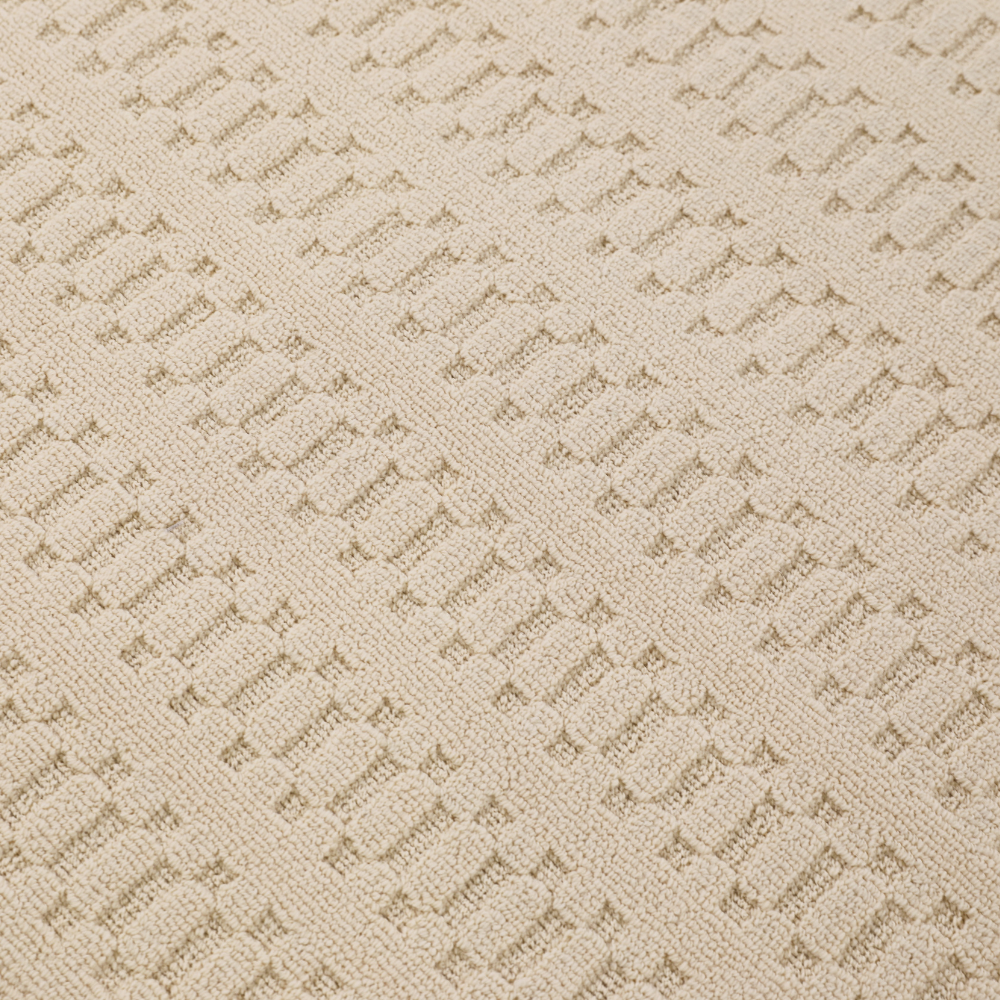 Textured beige woven rug, ideal for enhancing modern home interiors.