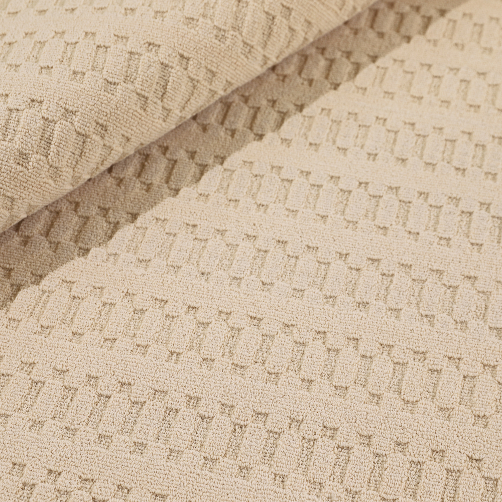 Beige woven rug with textured design, perfect for enhancing home interiors.