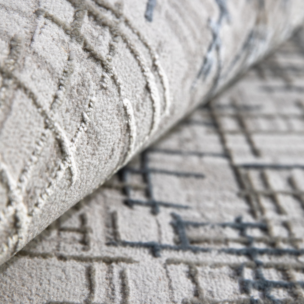 Velvet Reverie Stripes rug detail in gray and beige with modern abstract design.