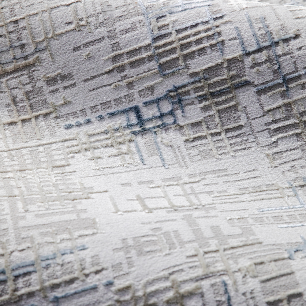 Velvet Reverie Stripes rug close-up in gray and beige with abstract design.