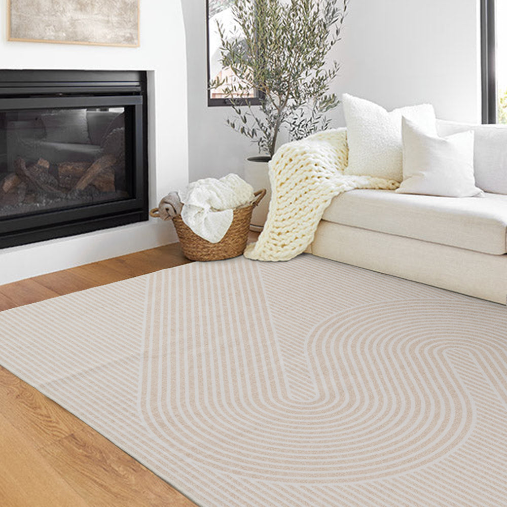 Light Serpentine Whisper rug with curved lines in a cozy living room setting