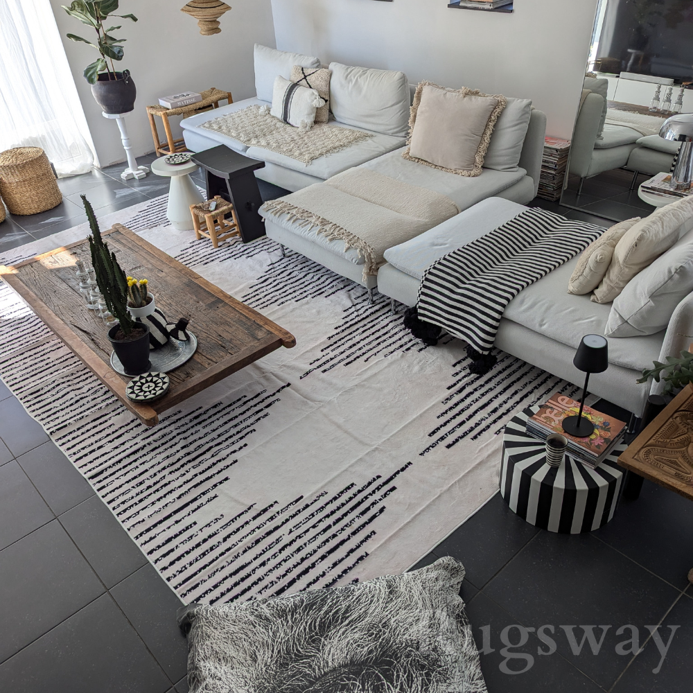 Desert Echo Geometric Rug in black and beige, enhancing a modern living room design.