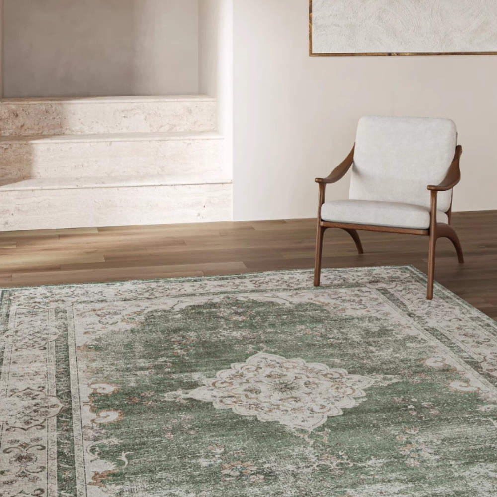 Vintage green and cream rug with floral design in a modern living space