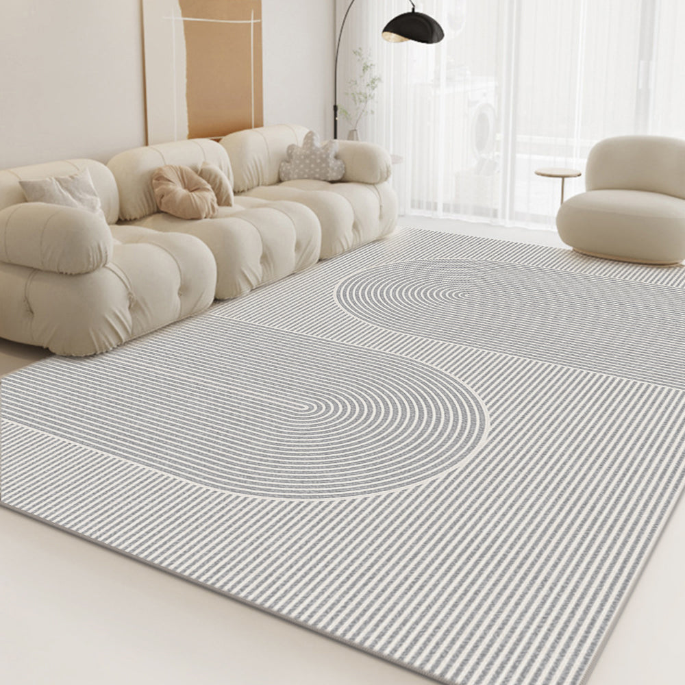 Modern rug with curved lines in neutral colors, enhancing a chic living room setting