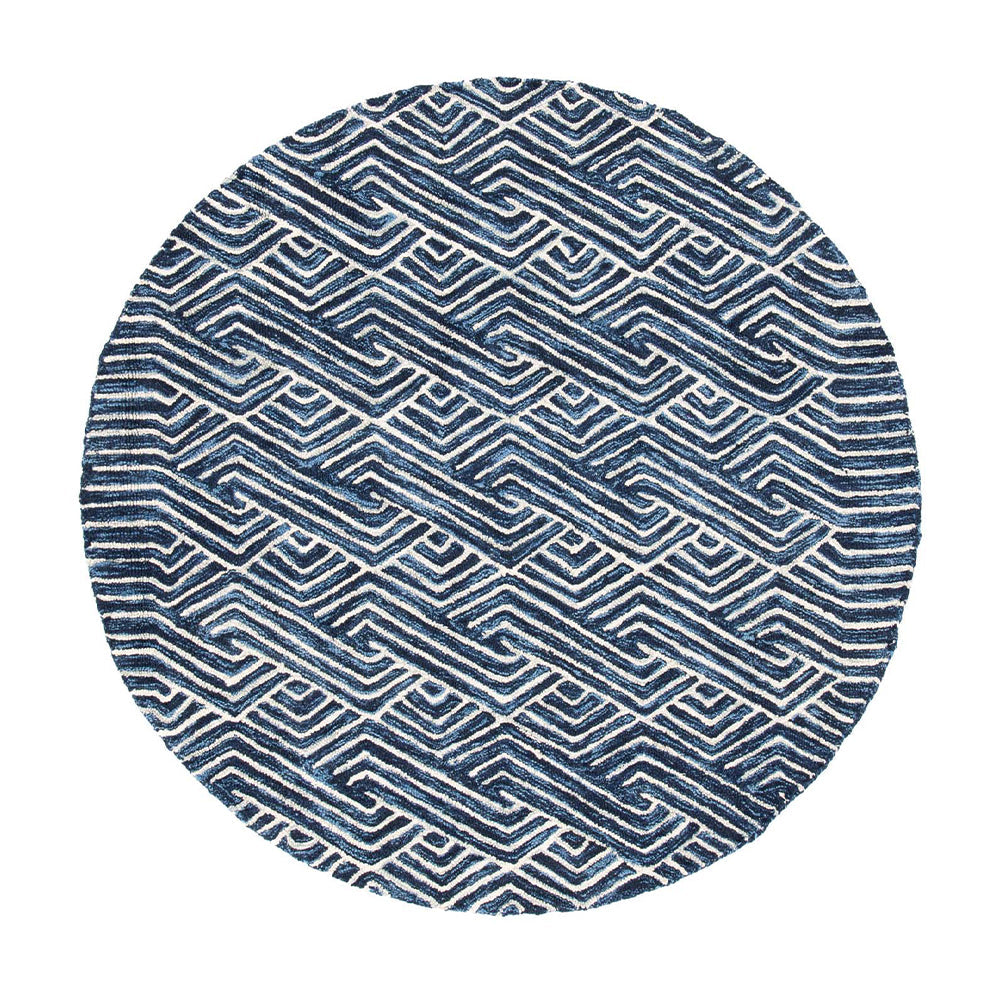 Round blue and white rug with wavy geometric pattern for stylish interiors.