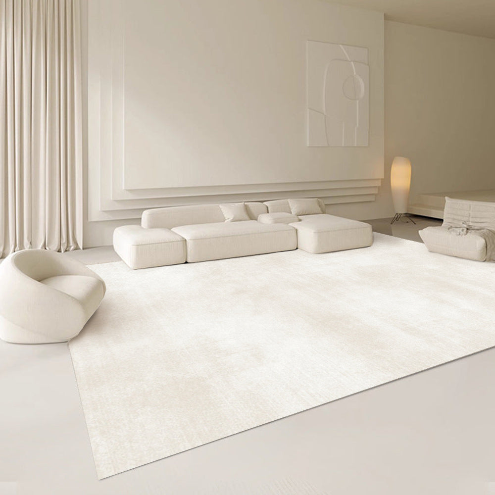 Light beige Scandinavian rug in a minimalist living room with modern furniture.