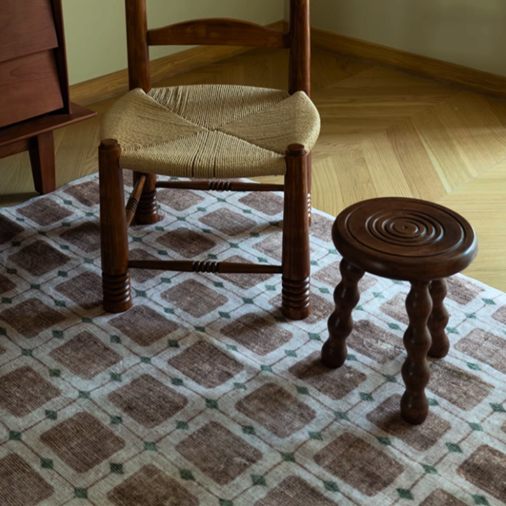 Perseus checkered washable rug in neutral tones under wooden furniture