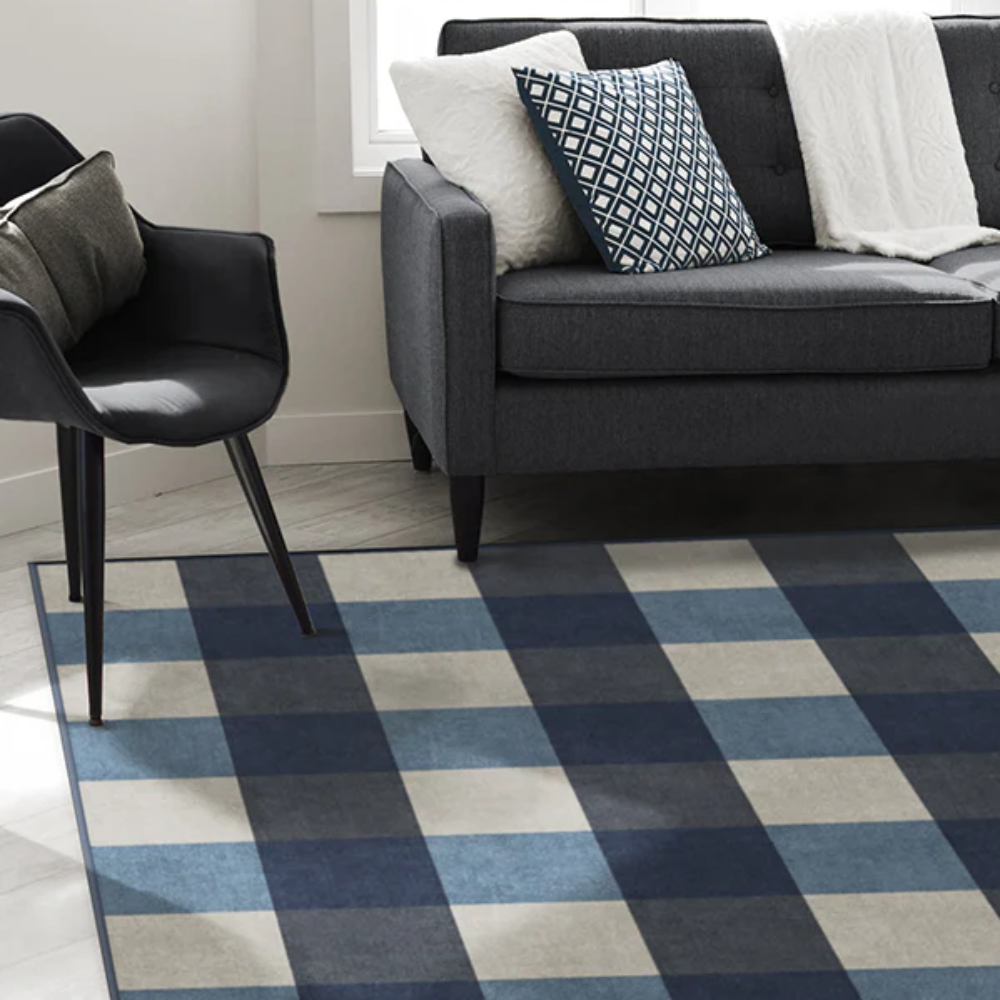 Nerina checkered washable rug in navy and beige under modern gray sofa