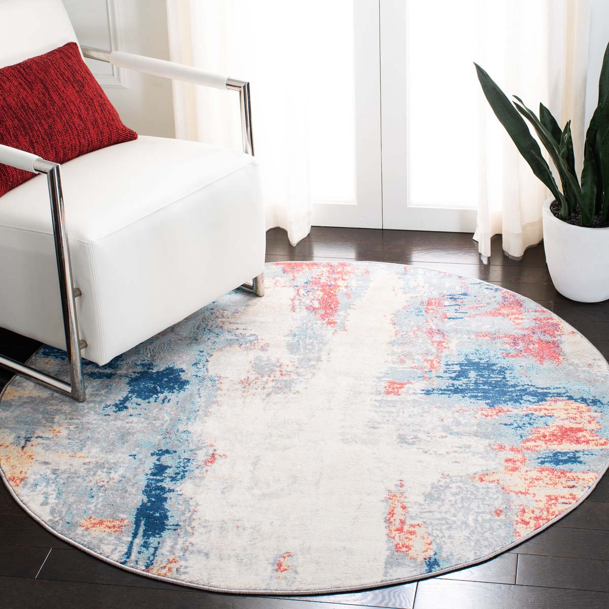 Round abstract washable rug in blue, red, and beige for contemporary living spaces.