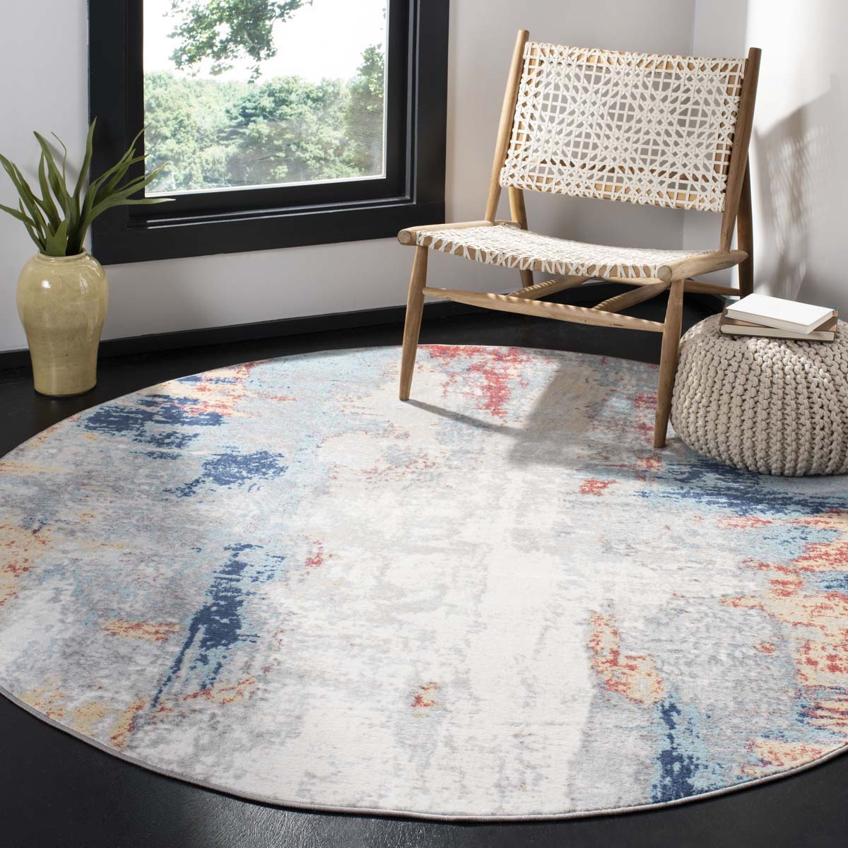 Round abstract washable rug with calming blue, red, and beige hues for modern interiors.