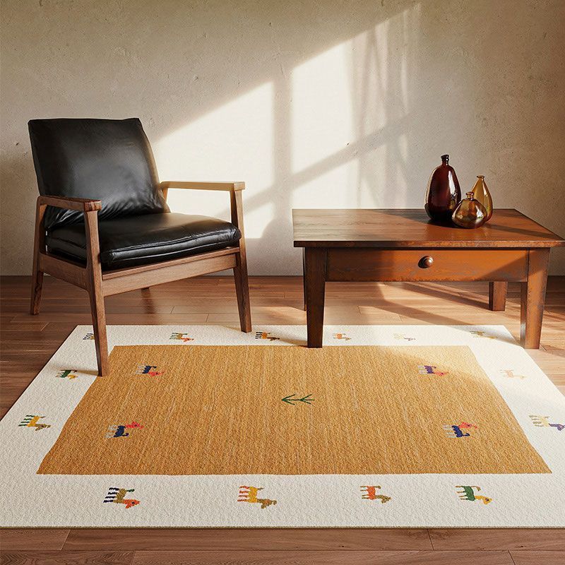 Warm brown center rug with horse border in a stylish living room setting