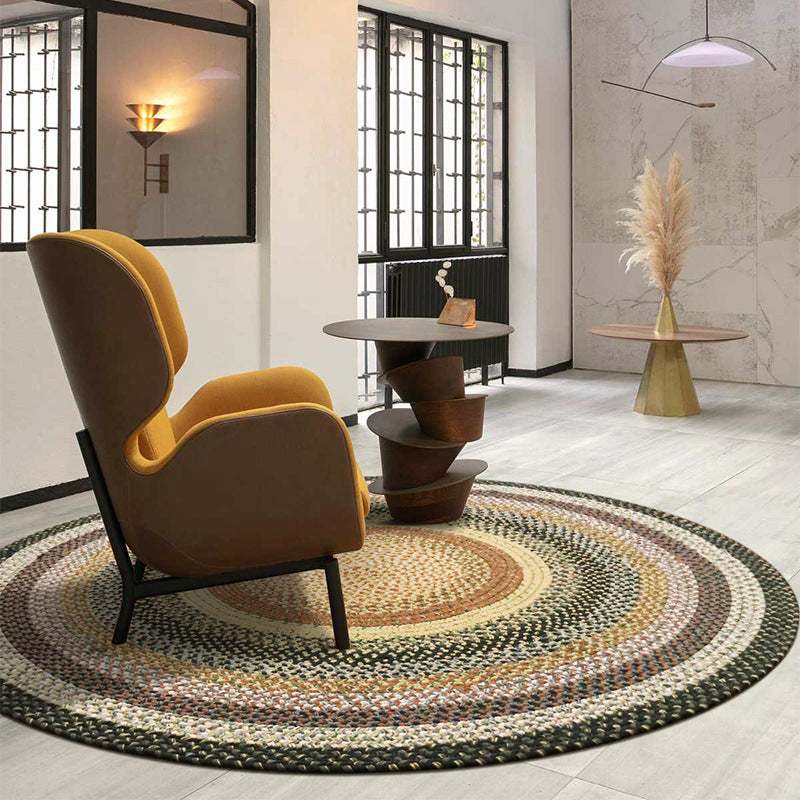 Round Faith Bohemian woven rug in warm concentric patterns, enhancing modern living space.