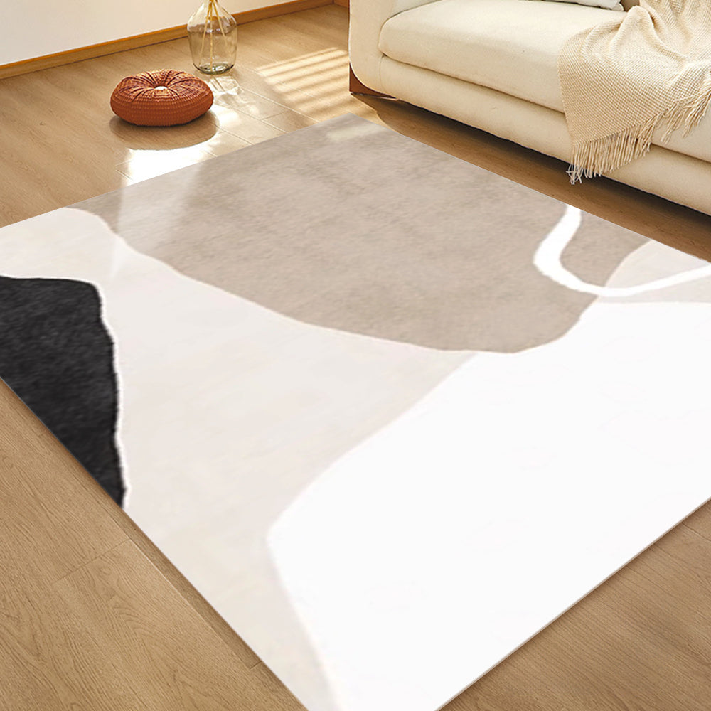 Washable abstract rug in beige, white, and black for modern living spaces.