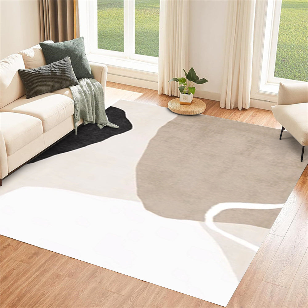 Neutral washable rug with abstract shapes in beige, black, and white