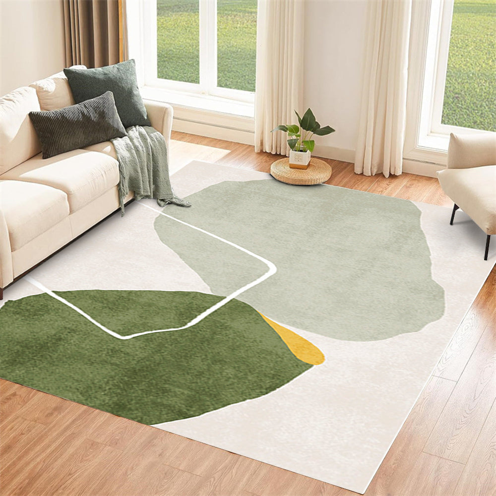 Modern abstract rug with green and beige shapes in a stylish living room setting.