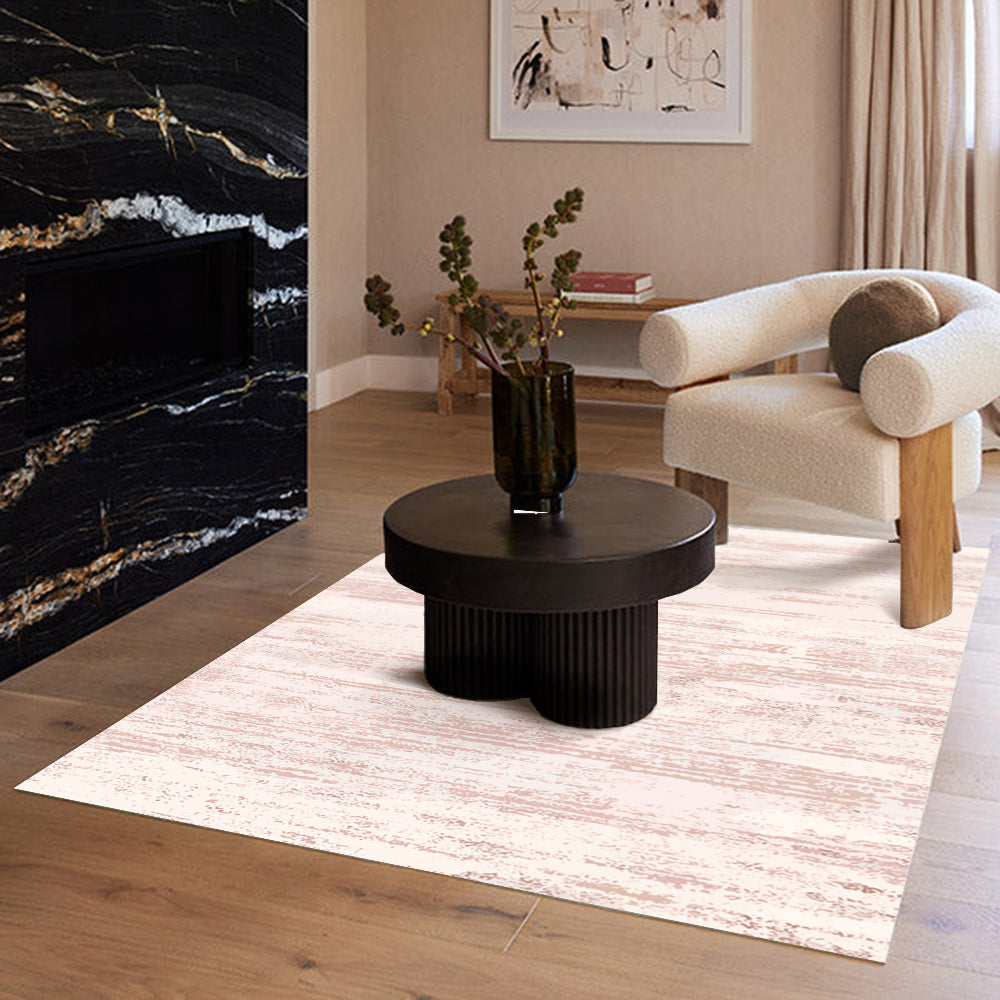 Textured beige rug with modern decor, featuring a round black table and vase.