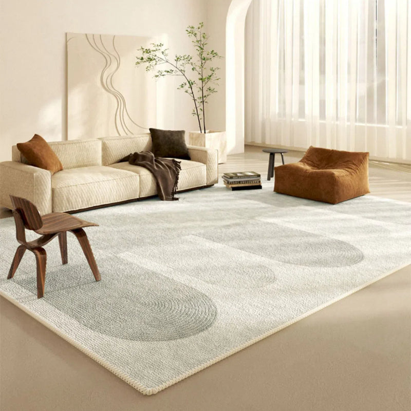 Gentle Waves Seren rug in soft gray with oval patterns, enhancing a modern living room.