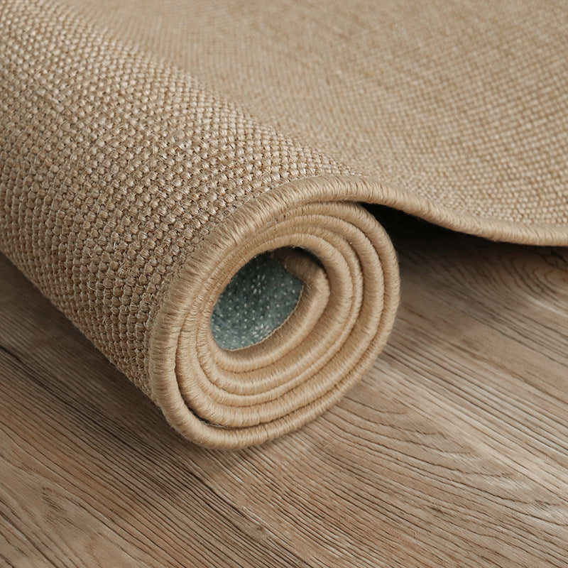 Rolled Finn Solids Outdoor Woven Jute Rug showcasing earthy texture