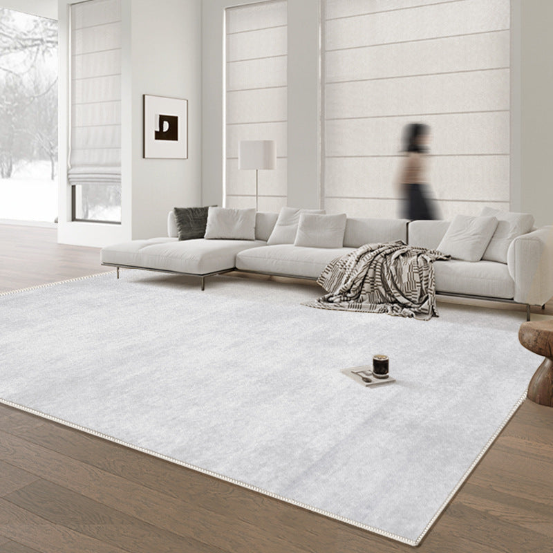 Modern light gray washable rug in contemporary living room setting