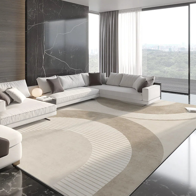 Beige geometric rug with curved patterns in contemporary living room setting.