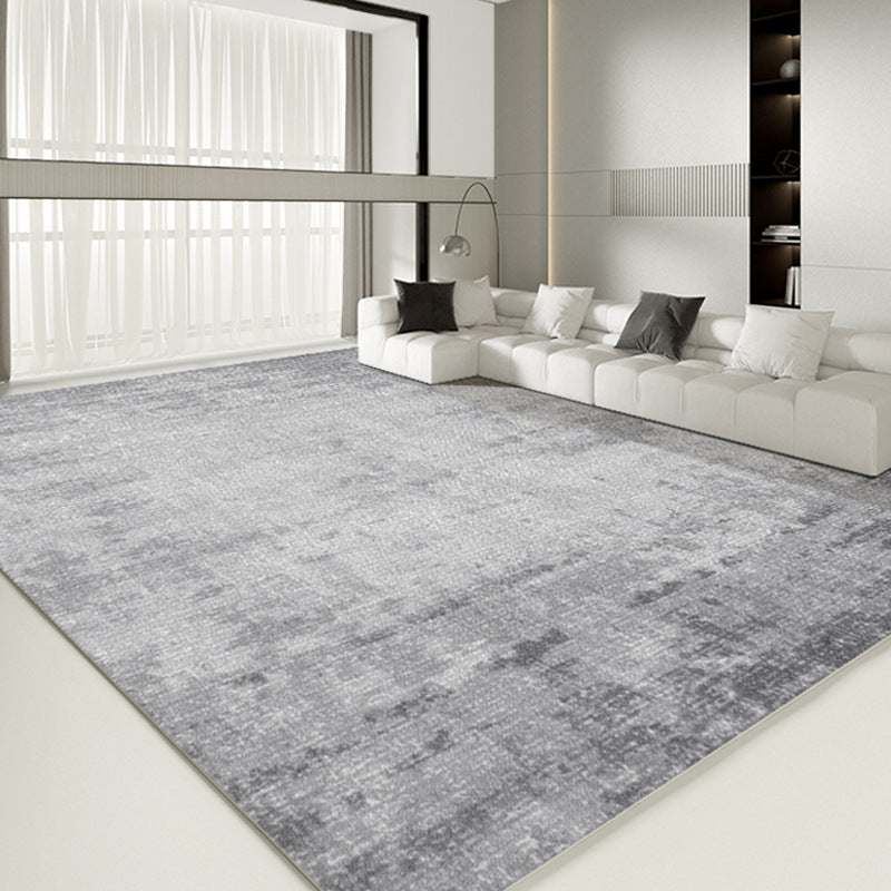 Contemporary gray rug in modern living room with minimalist white sofa.