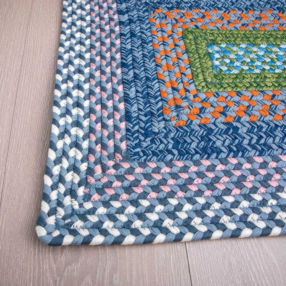 Multicolored braided Starlit Horizon outdoor rug with blue, green, and orange patterns