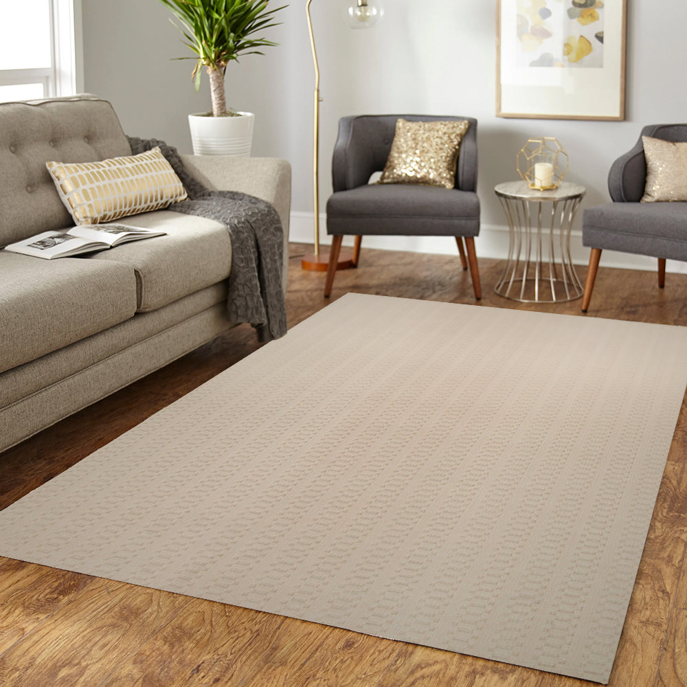 Beige textured modern rug enhancing a cozy living room with stylish gray sofa and decor.