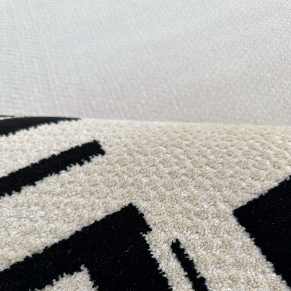 Cream and black textured rug, perfect for modern home decor.