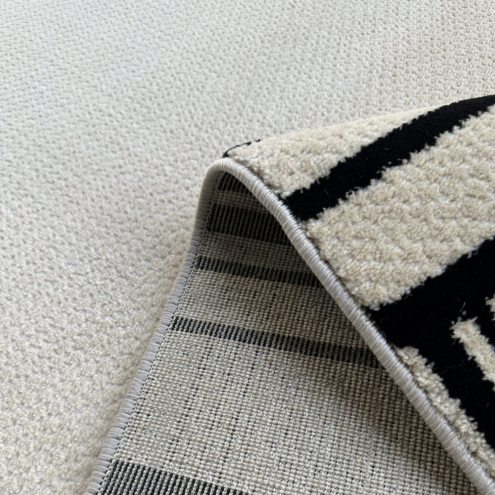 Textured cream and black Fiora rug, perfect for stylish modern interiors.